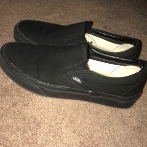 All black Vans slip-ons